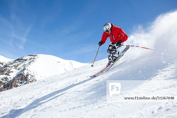 Skier  skiing downhill  low angle view