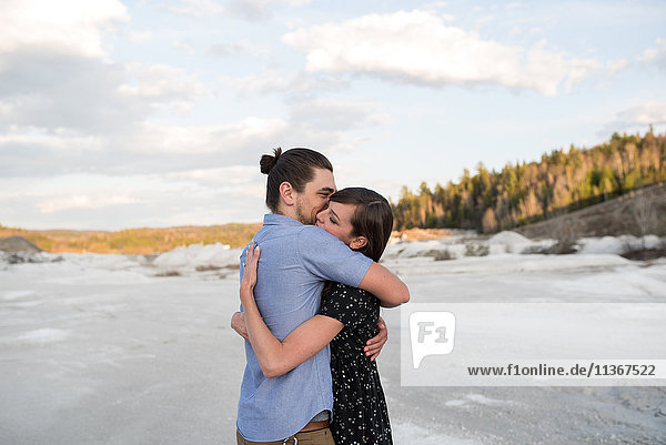 Couple hugging on snow-covered landscape Ottawa Ontario