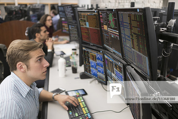 Young traders analyzing computer data