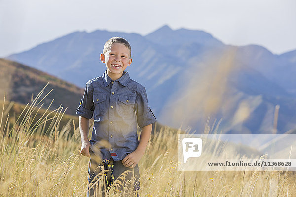 USA  Utah  Provo  Boy (6-7) standing in field