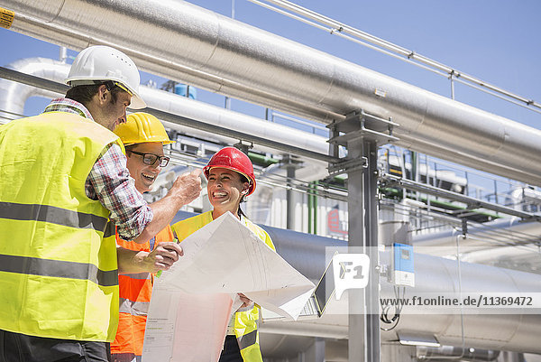 Ingenieur und Arbeiter bei einer Besprechung auf dem Gelände eines geothermischen Kraftwerks