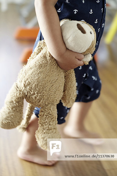 Child holding stuffed toy