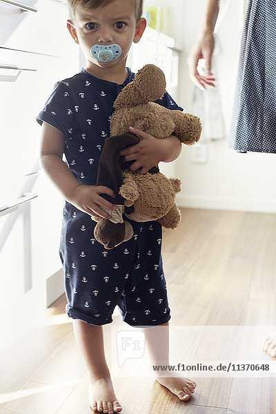 Boy holding stuffed toys