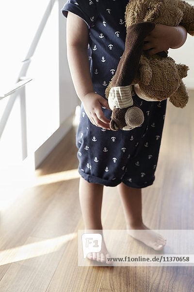 Child holding stuffed toys