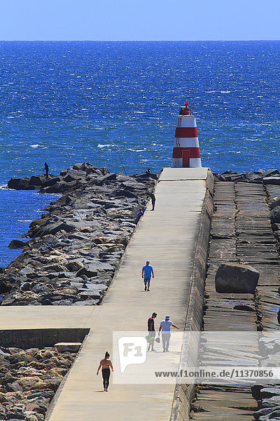 Portugal  Algarve  Portimao. People walking on the embankment.