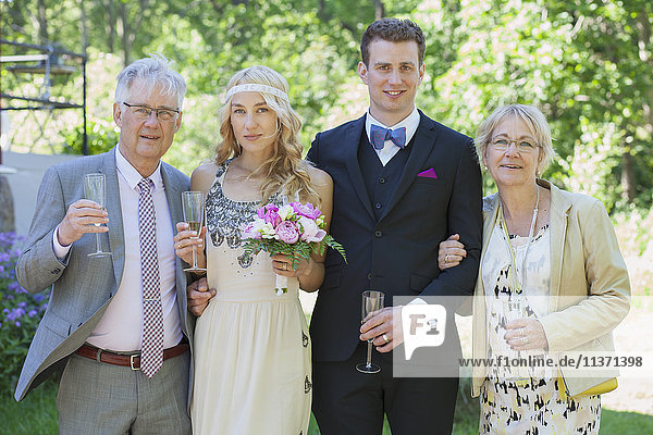 Portrait of bride and groom with parents