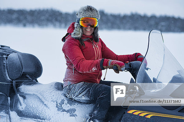 Woman on snowmobile