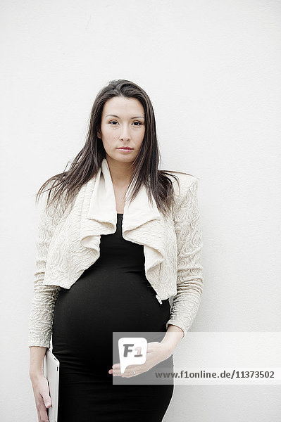 Portrait of pregnant woman on white background