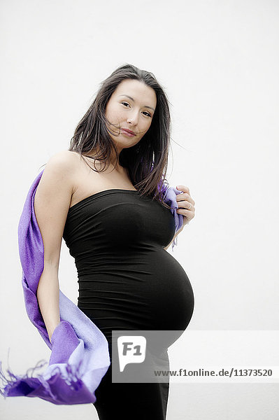 Portrait of pregnant woman on white background