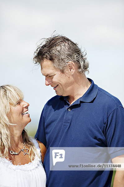 Mature man and woman looking at each other