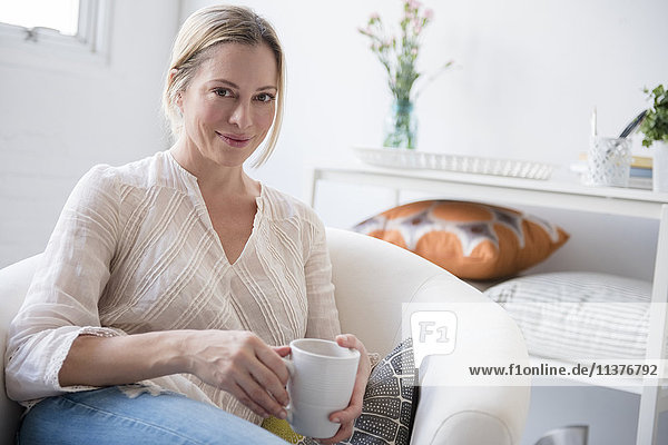 Portrait of Caucasian woman drinking coffee