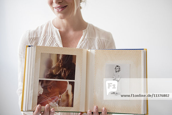 Caucasian woman showing photo album