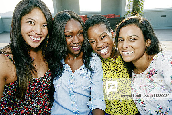 Smiling women posing on rooftop