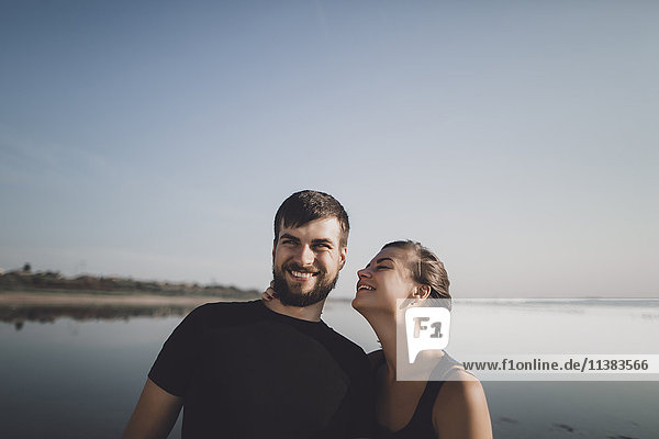 Caucasian couple smiling near lake
