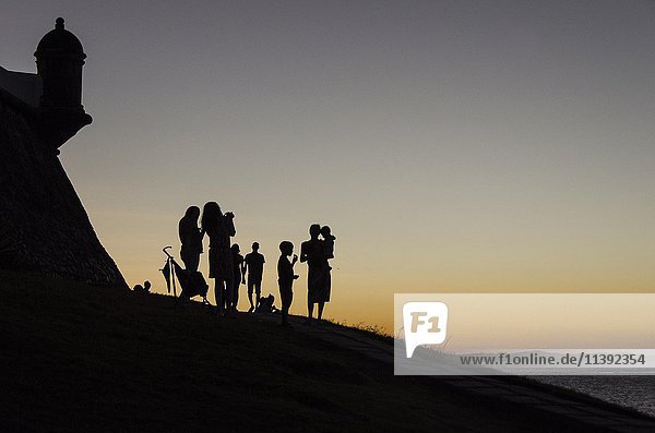 Adults and children at sunset  Farrol da Barra  Salvador  Brazil  South America