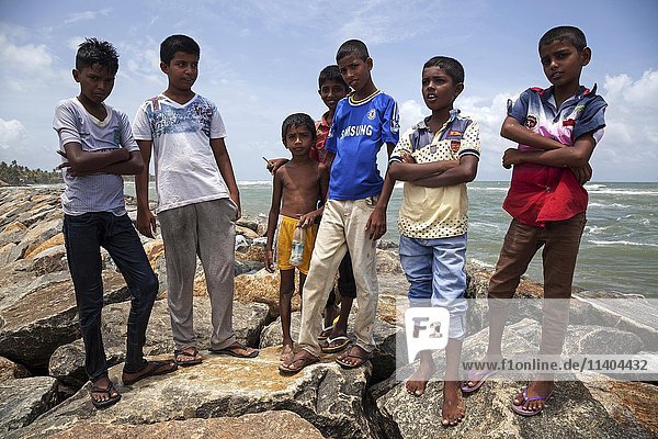 Local children on breakwater in harbour  Beruwela  Western Province  Sri Lanka  Asia