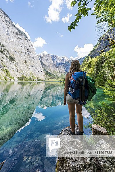 Young woman  hiker at Lake Obersee  reflection in water  Salet am Königssee  National Park Berchtesgaden  Berchtesgadener Land  Upper Bavaria  Bavaria  Germany  Europe