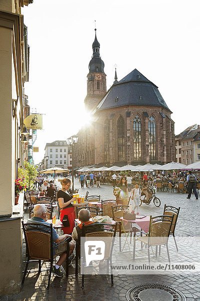 Restaurants und Straßencafés entlang des Marktplatzes mit der Heilig-Geist-Kirche in Heidelberg  Baden-Württemberg  Deutschland  Europa