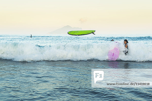 'Beginner surfers suffering from the strength of the ocean Waiao beach Yilan County; Taiwan China'