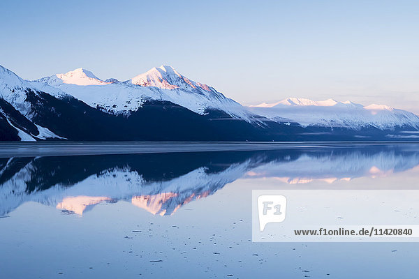 'Snow covered mountains across Turnagain Arm in springtime  near Mile 87 of the Seward Highway; Alaska  United States of America'