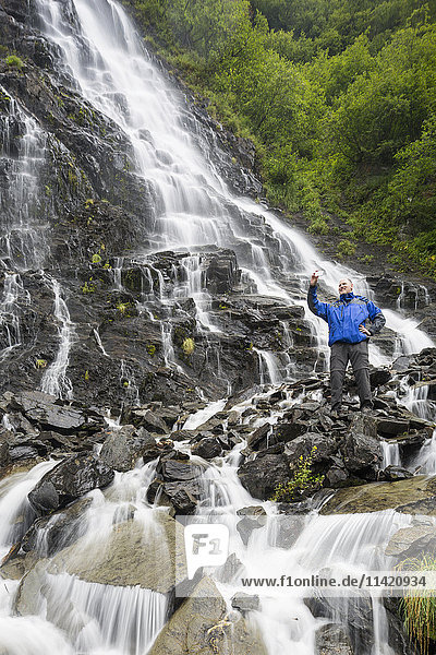 Tourist taking a selfie at Bridalveil Falls  Keystone Canyon  Valdez  Southcentral Alaska  USA