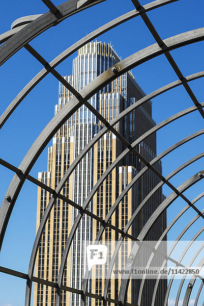 'View of a skyscraper through a metal structure; Minneapolis  Minnesota  United States of America'