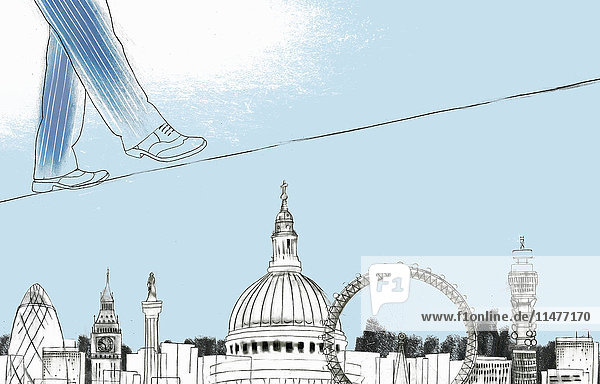 Businessman walking on tightrope above sights of London
