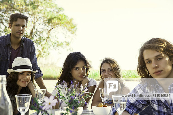 Friends enjoying meal together outdoors  portrait