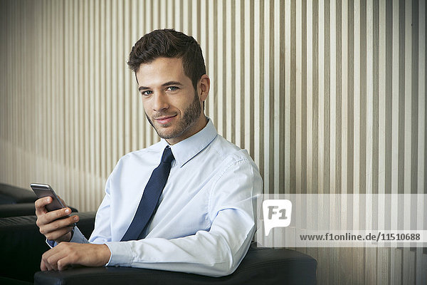 Businessman using smartphone  portrait