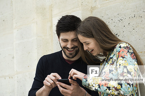Couple using smartphone together