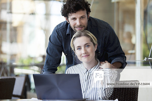 Couple using laptop computer together at home