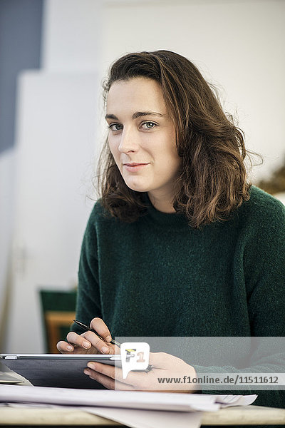Woman using digital tablet  portrait
