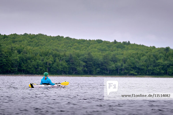 Kayaker kayaking  Kejimkujik Lake  Nova Scotia  Canada