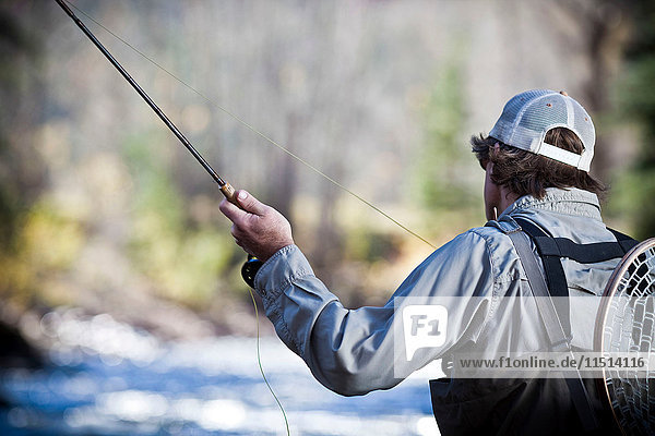 Fisherman fly fishing
