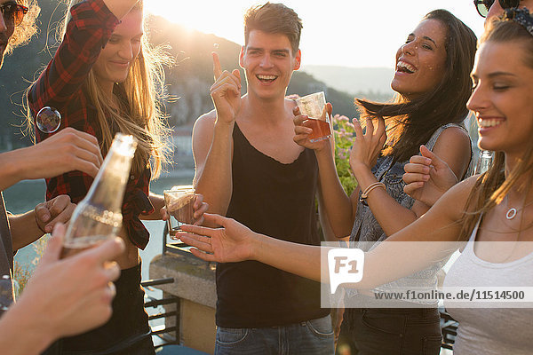 Erwachsene Freunde feiern auf der Dachterrasse am Wasser  Budapest  Ungarn