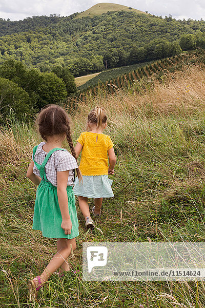 Two young girls exploring outdoors