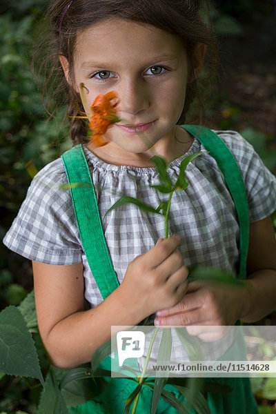 Portrait of young girl  holding flower