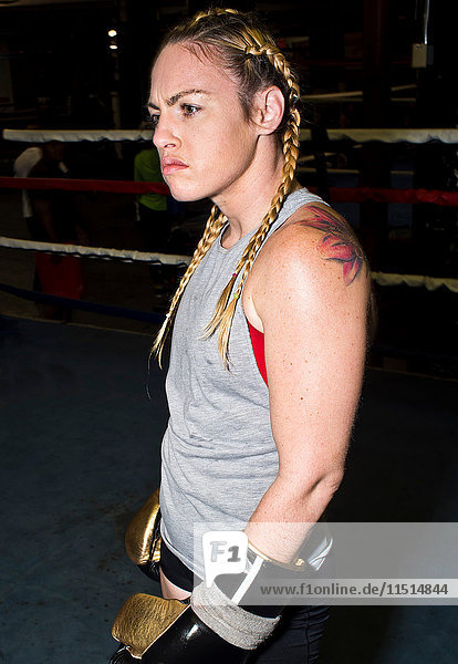 Aggressive female boxer in boxing ring