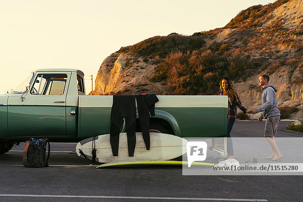 Surfing couple with pickup truck at Newport Beach  California  USA