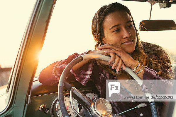 Junge Frau  die sich im Pickup-Truck in Newport Beach  Kalifornien  USA  gegen das Lenkrad lehnt