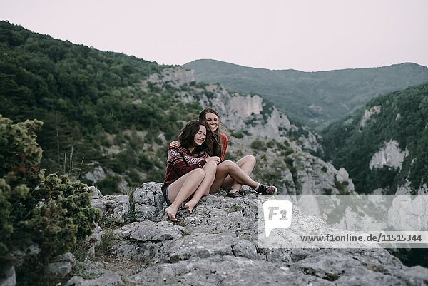 Caucasian women hugging on mountain