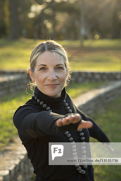 Portrait of Caucasian woman practicing yoga in park