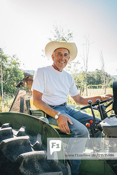 Kaukasischer Bauer auf Traktor sitzend