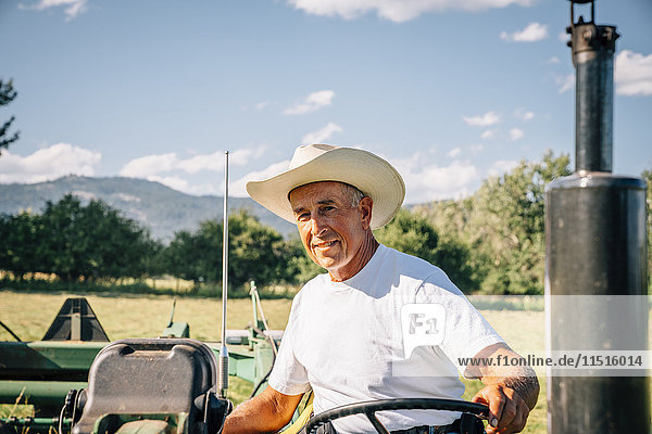 Portrait of Caucasian farmer on tractor