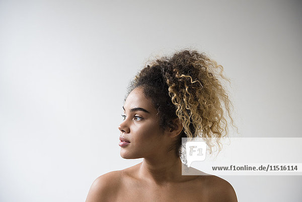 Mixed Race woman with bare shoulders looking away