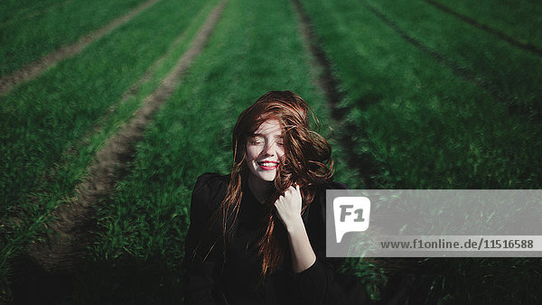 Smiling Caucasian woman in rows of grass