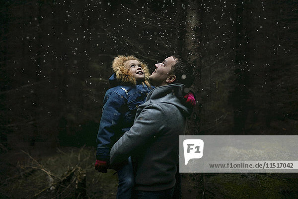 Caucasian father and daughter under starry sky