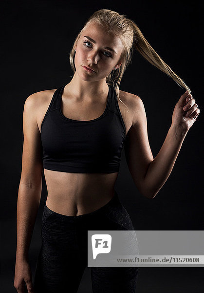 Portrait of teenage girl wearing sports clothing  studio shot
