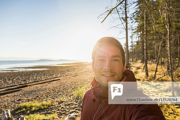 Sunlit portrait of man at Rathrevor Beach Provincial Park Vancouver Island British Columbia Canada