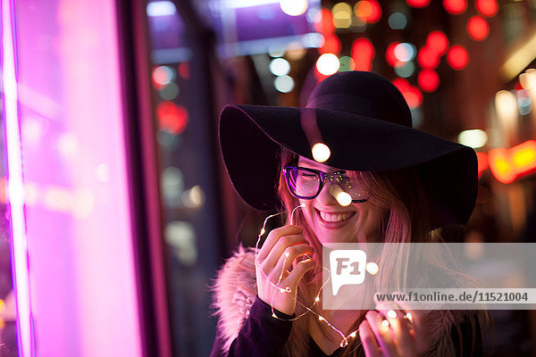 Young woman holding neon lights  London  UK